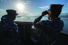 U.S. sailors on the bridge of the USS Ramage monitor a Spanish frigate as it departs Souda Bay during their scheduled deployment supporting maritime security operations and theater security cooperation efforts in the U.S. 6th Fleet area of responsibility.