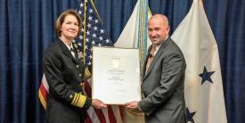 DISA Director Vice Adm. Nancy A. Norton, USN, presents Steve Wallace with his promotion certificate as he takes over the agency’s newly created Emerging Technology (EM) Directorate.