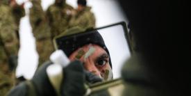 Army Sgt. K.C. Pless applies camouflage paint before a multinational weapons training session with Danish troops in Estonia on March 10 in support of support Operation Atlantic Resolve. As the Army operates in an ever-changing world, the service’s military intelligence needs to provide a counter to the evolving threats. Army photo by Spc. Hubert D. Delany III