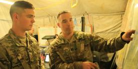 2nd Lt. Shane Neal, USA, receives guidance from Capt. Douglas Gain, USA, as they review the Cyber and Electromagnetic Activities Team’s plans during Exercise Saber Junction 2019 at the Grafenwoehr Training Area, Germany. Credit: U.S. Army