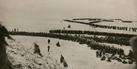 Thousands of British and French troops wait on the dunes of Dunkirk Beach, France, for transport to England during World War II, between May 26 and June 4, 1940. The Central Intelligence Agency cites the military evacuation of Dunkirk as the time its predecessor agency started depending on the private sector for key strategic intelligence. Credit: Shutterstock/Everett Historical