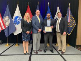 Saim Bashir (2nd from right), a Marine Corps veteran studying at George Mason University, receives his AFCEA War Veterans Scholarship from (l-r) Tamara Greenspan, president, NOVA Chapter; Robin P. Swan, director, Office of Business Transformation, Office of the Secretary of the Army; and Chuck Griffith, chapter vice president of programs, NOVA chapter.