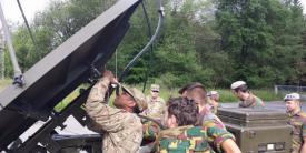 U.S. soldiers from the 2nd Theater Signal Brigade and Belgian soldiers from the 6th Communication and Information Systems (CIS) Group pass voice and data through a Belgian satellite terminal during Operation Combined Lightning last June.