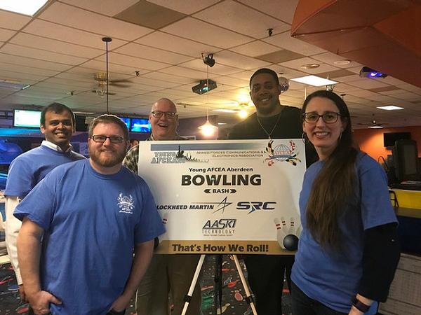 The team from Ad Hoc Research Associates strikes a pose at the March Bowling Bash, hosted by the chapter's Young AFCEANs.