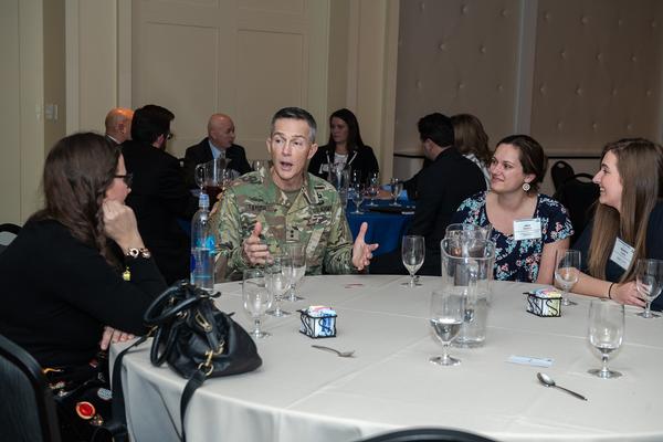 Maj. Gen. Randy Taylor, USA, commanding general of the U.S. Army Communications-Electronics Command, and senior commander for APG, speaks to a table of young women during a speed mentoring session at the February event.