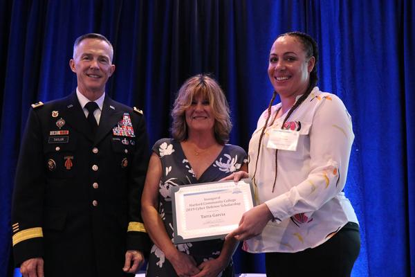 In May, Angela Sheldon, chapter president, and Maj. Gen. Randy Taylor, USA, present the first annual Cyber Defense Scholarship to Tarra Garcia, student of Harford Community College, Bel Air, Maryland.