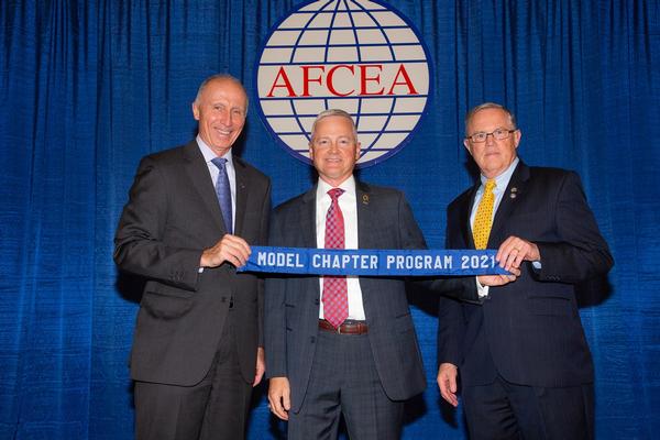 In October, Col. Bill Montgomery, USA (Ret.), chapter president, accepts the award from Lt. Gen. Robert Shea, USMC (Ret.), president and CEO of AFCEA International.