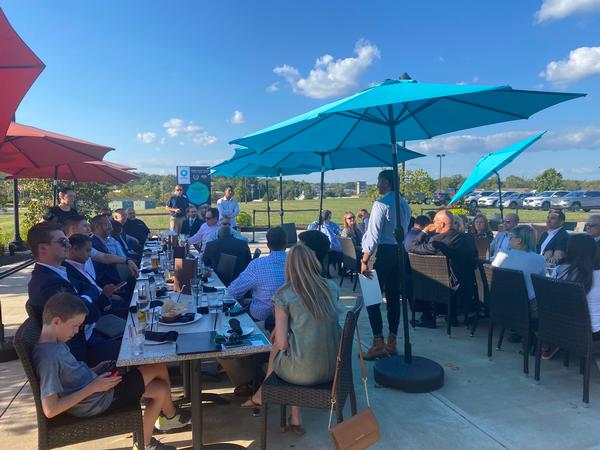 Bharat Patel, product lead for Project Linchpin under Program Executive Office Intelligence Electronic Warfare & Sensors, addresses the Emerging Leaders crowd at the Bacco outdoor patio during 