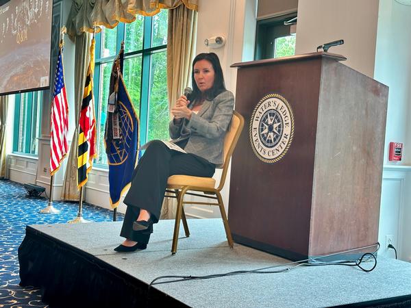 Danielle Moyer, executive director of Army Contracting Command-Aberdeen Proving Ground, addresses the crowd in a fireside chat in May.