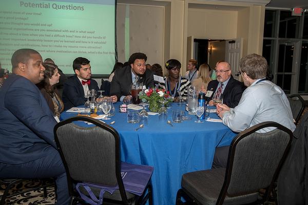 Martin (2nd from r) mentors a table of young professionals focusing on work life balance and professional development at the annual mentoring event in November.