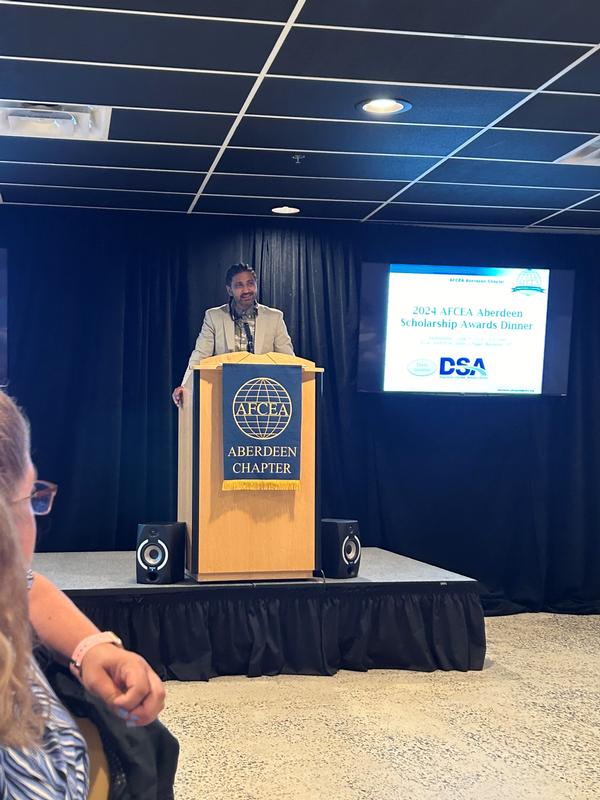 Keynote speaker Bharat Patel, product lead for Project Linchpin under Program Executive Office, Intelligence, Electronic Warfare & Sensors, addresses the crowd at the June event.