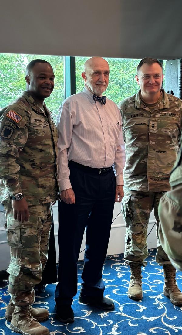 Speakers (l-r) Daiyaan, Justice and Maj. Gen. Patrick Ellis, director of the Command and Control (C2) Cross Functional Team, pose for a photo during the May luncheon. Photo by Katherine Kage