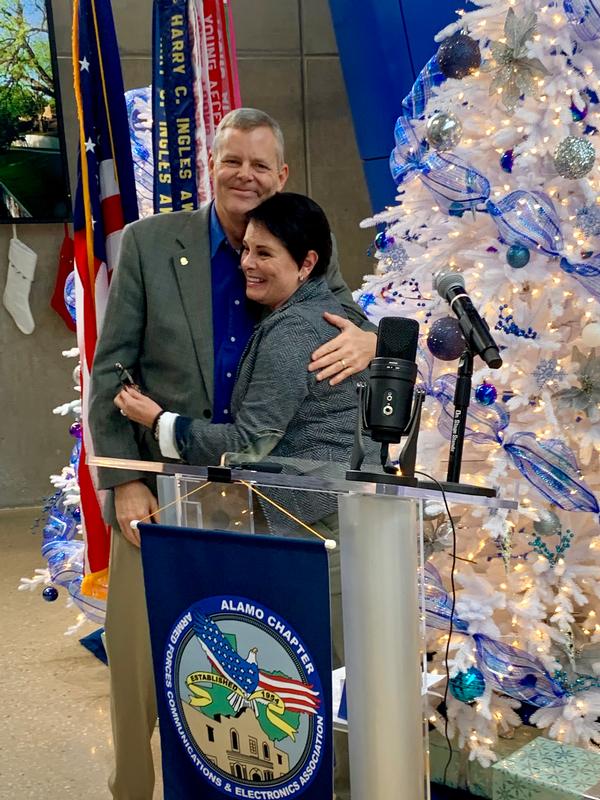 Chapter President, Rick Lipsey, presents KJ Howell of Abacus Technology Corporation a coin during the chapter's December monthly luncheon. Howell is the chapter's Volunteer of the Month for December. She has served the chapter since 2017 and dedicates her volunteer time to the publicity team as the chapter's photographer, social media and marketing designer.
