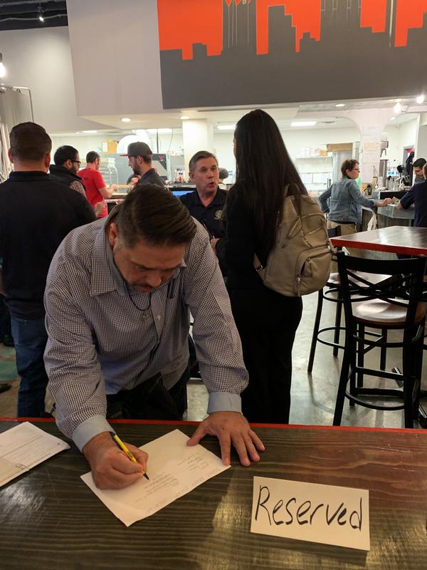 An attendee signs in at the Back Unturned Brewery for the Alamo Chapter's YAC "Tech on Tap" social. The event brings together a mix of professional backgrounds to mingle and network together in a social setting.