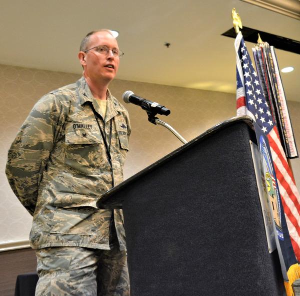 Col. Scott O'Malley, USAF, vice commander, 688th Cyberspace Wing, Joint Base San Antonio–Lackland, addresses chapter members and attendees during their March luncheon. 