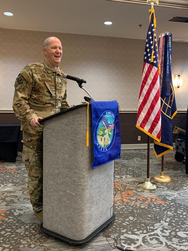 Col. Ty Gilbert, USAF, commander, 543rd Intelligence, Surveillance and Reconnaissance Group, Joint Base San Antonio-Lackland, Texas, laughs with attendees and members during the chapter's first live streaming luncheon event in October.