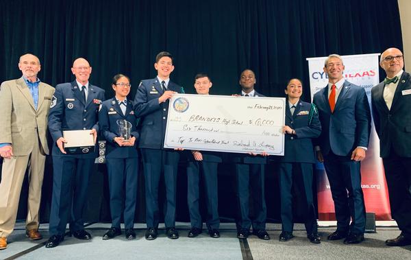 In February, Dave Kovach, chapter executive vice president, presents a check for $6,000 in scholarships to the Finalist Team High School All-Service Division, Brandeis High School Air Force junior ROTC during the San Antonio Mayor's Cyber Cup. 