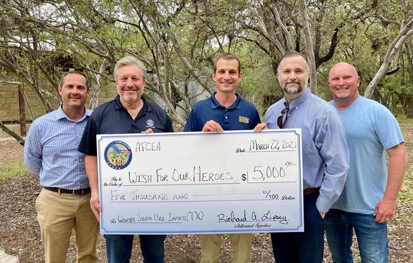 Jeff Kendall, chapter vice president, veteran support and military family outreach and Wounded Warrior and Military Families (W2MF) chair (center l), and W2MF committee members stand with Jeff Wells (center), CEO and president of Wish for OUR HEROES, during a donation presentation in April.