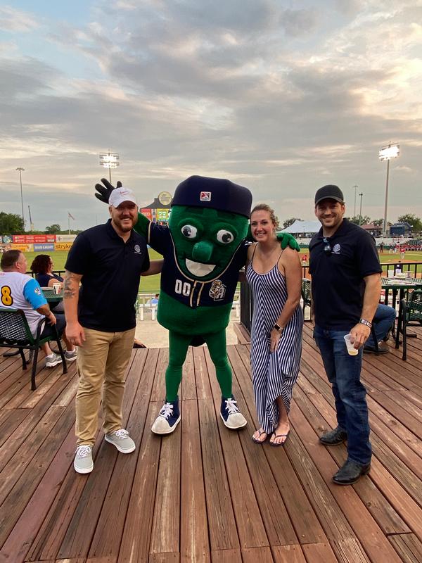 In July, (l-r) Justin Newell, Brianna Oberg and Shawn Cressman, vice president of Emerging Leaders, pose with the San Antonio Missions mascot, Ballapeno, a spicy jalapeño! The chapter's Emerging Leaders enjoyed baseball and networking for their first in-person event since the start of the pandemic.