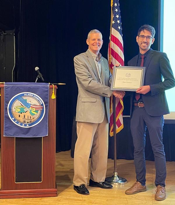 Rick Lipsey, chapter president, presents the Dr. Ralph W. Shrader Graduate Diversity Scholarship on behalf of the AFCEA Education Foundation to Sean Garnsey at the chapter's August luncheon at Randolph Air Force Base.