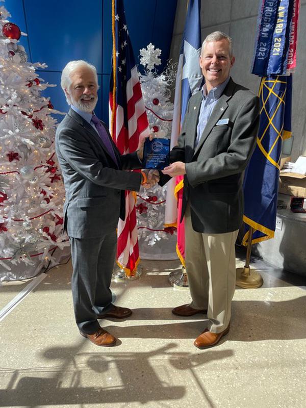 Rob Licciardi, former chapter vice president of programs (l), presents Rick Lipsey, chapter president, the prestigious General James M. Rockwell AFCEAN of the Year for 2021 during the chapter's last luncheon of the year in December.<br />