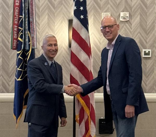 Ralph Franco, information technology infrastructure program manager, Defense Health Agency (l), and Chris Kinne, chapter president, pose for a photo at the August event.
