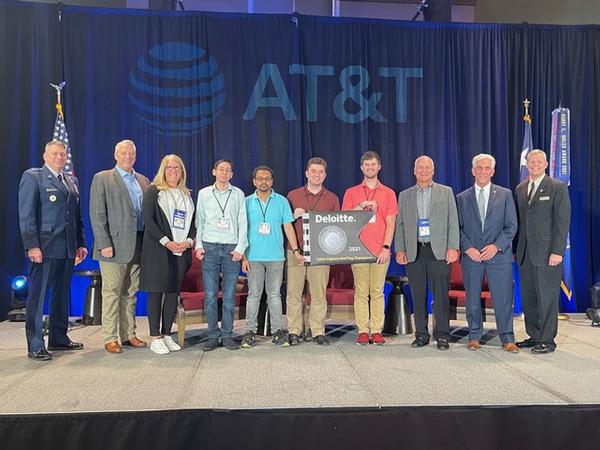 This year's Capture the Flag university-level winners pose for a photo at the November event.