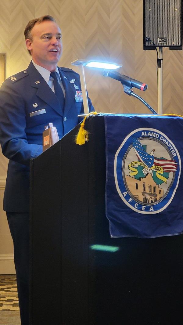 Col. Aaron Drake, USAF, special assistant to the commander, 16th Air Force, speaks at the March luncheon.