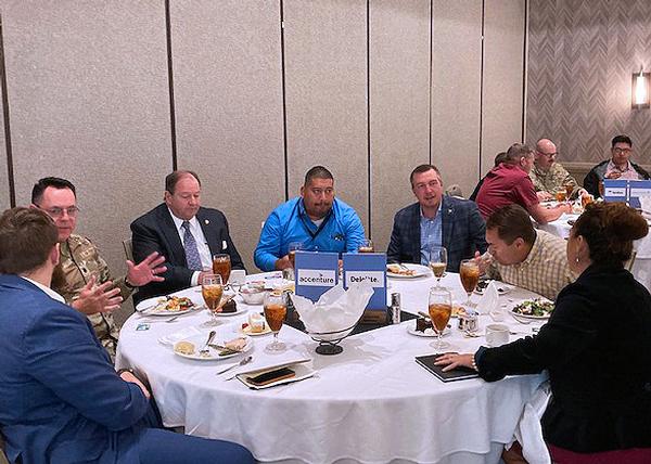 Chapter members and attendees of the October monthly luncheon network among the different industry, academic and government individuals.