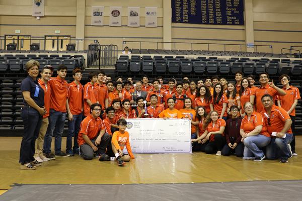 Chapter Vice President of Scholarships and Educational Grants Karen Rolirad (l) presents a grant to young competitors from United Engineering and Technology Magnet in Laredo, Texas, which won both Best and Overall Division awards in October. 
