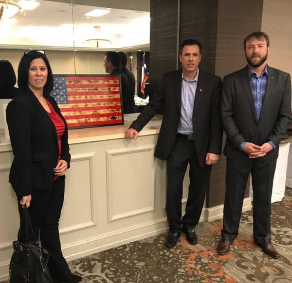 During the chapter's March luncheon, Warriors Heart co-founder Lisa Lannon, with CEO and co-founder Josh Lannon (c) and Staff Sgt. Christian Bagge, USA (Ret.), presents a handmade wooden flag as a token of appreciation for the chapter's $10,000 donation. Bagge, a Purple Heart recipient and Warriors Heart alumni, made the flag. Warriors Heart is a nonprofit center for treatment of post-traumatic stress disorder (PTSD), addiction and chemical dependency in active-duty service members, veterans and first responders. The donation presented to Warriors Heart is part of the chapter's Wounded Warrior and Military Families Endowment Fund that gives back to the local community.