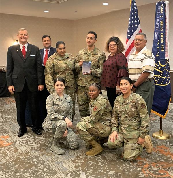 The Air Education and Training Command's Application Management Team accepts the Meritorious Rising Star for Achievement in IT Award during the chapter's October luncheon.