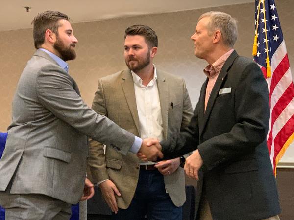 Chapter President Rick Lipsey (far r), congratulates Chris Benett (far l) and Dillon Watkins of TEKsystems for their outstanding effort as chapter volunteers at the October luncheon. The chapter has initiated a Volunteer of the Month program to recognize volunteers going above and beyond in their duties to the chapter.