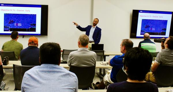 Hall discusses how he uses artificial intelligence to train a model at the July event.