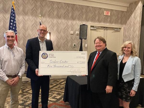 The chapter presents the Scobee Center with a $5,000 check to assist with their STEM-related programs during the December monthly luncheon.