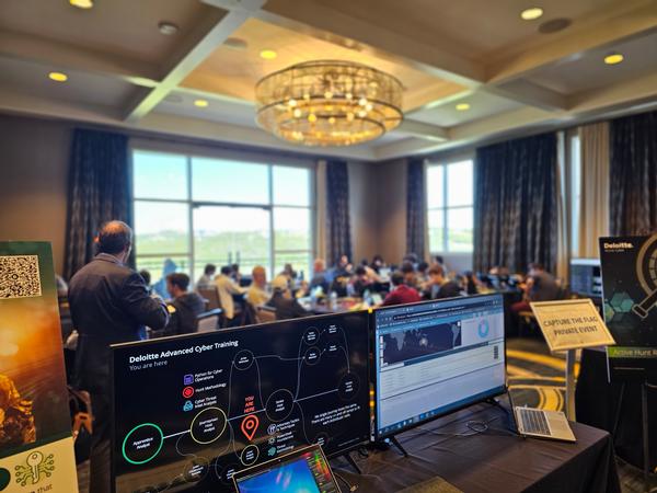 In November, conference attendees participate in a capture-the-flag event sponsored by Deloitte.