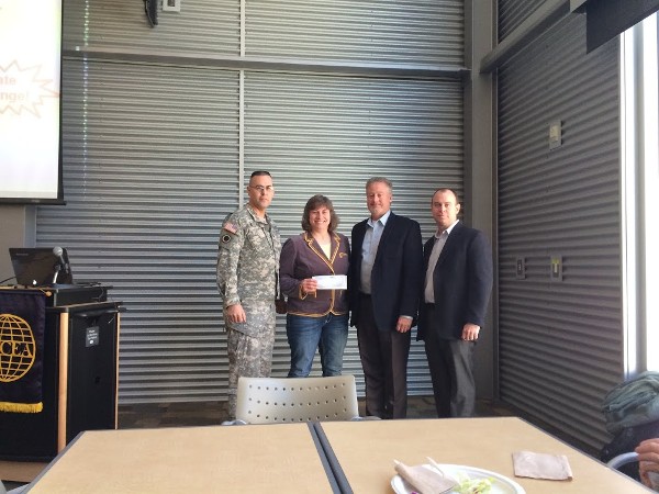 Lt. Col. Dave Elder, USA (l), chapter president, and Laura Bender, chapter secretary, accept a corporate sponsorship check from Kurt Norby (2nd from r) and Kevin Machon of Copper River IT at the February luncheon.