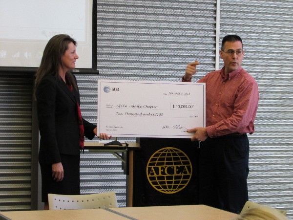 Electa Kean from AT&T presents Chapter President David Elder with a $10,000 check in January for the chapter to continue supporting growth in the information technology fields.