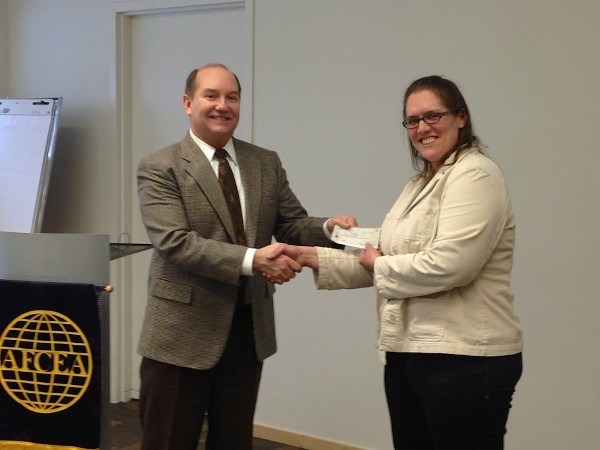 Steve Gebert, representing Alaska Communications, and a member of the chapter's board of directors, presents Mary Watts, Pioneer Peak Elementary School, with a STEM grant for $1,000 in February.