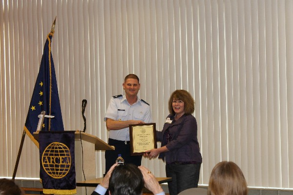 At the April meeting, Lt. Col. Brian Hippel, USAF, chapter president, presents Gillian Dezzutto, chapter first vice president, with a certificate of significant achievement recognizing her tremendous work for the chapter over the last two years.