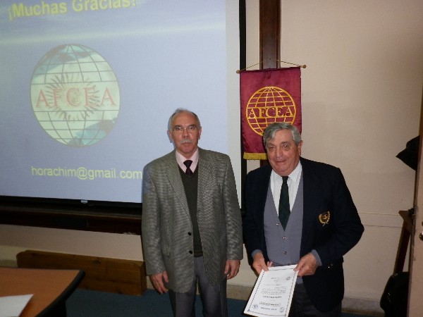Rear Adm. Emilio Nigoul, ARA (Ret.) (r), chapter president, presents a certificate of recognition to Col. Oscar Gonzalez, FAA (Ret.), chapter board member and coordinator of the October symposium.