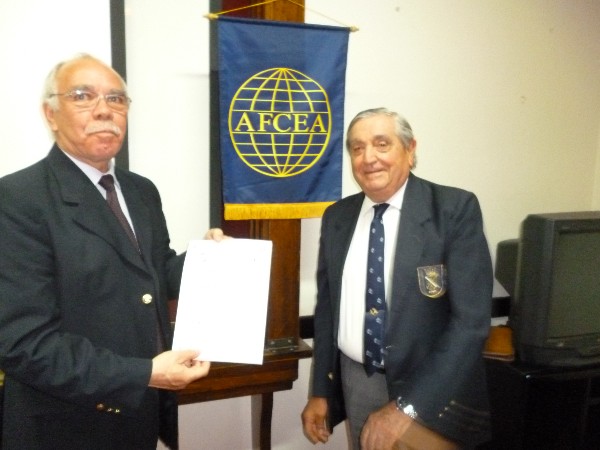 Col. Oscar Gonzalez, FAA (Ret.) (l), chapter board member, receives a certificate of recognition from Rear Adm. Emilio Nigoul, ARA (Ret.), chapter president, in September.