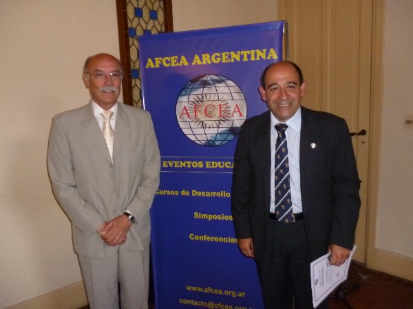 Lt. Col. Fernando Galletta, EA (r), Security Chief Government House, receives a certificate of appreciation from Carlos Amaya, academic coordinator and moderator of the chapter's October professional development course.