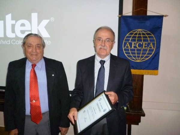 Daniel Lupi (r), president, Nanotechnology Argentina Foundation, receives a Distinguished Membership Award from Rear Adm. Emilio I. Nigoul, ARA (Ret.), chapter president, in August.