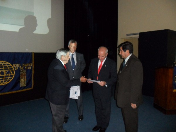 Rear Adm. Emilio Nigoul ARA (Ret.) (l), chapter president, presents a certificate of recognition to Col. Luis Rabago, EA (Ret.) (c), who is joined by Col. Daniel Tello, EA (Ret.), chapter first vice president, at a conference in May.
