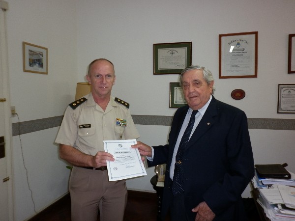 In December, Rear Adm. Emilio Nigoul, ARA (Ret.), chapter president, presents a Science Teaching Tools grant check and certificate to Col. Javier Marturet, EA, secretary of education. 