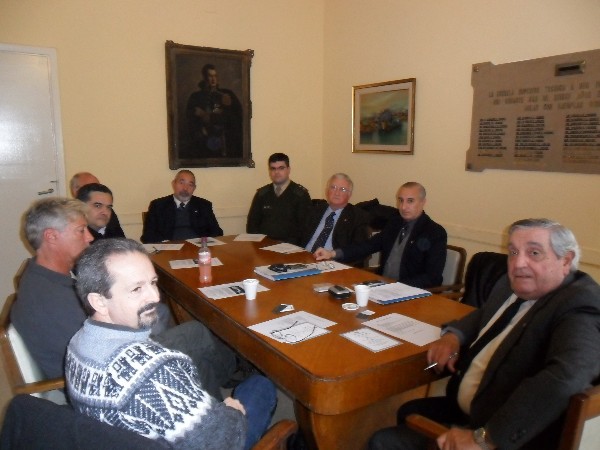 Rear Adm. Emilio I. Nigoul, ARA (Ret.) (r), chapter president, presides over the July board meeting with 1st Lt. Eduardo Malvacio, Argentine Army (2nd from r), president of the Argentina Student Subchapter, and Eduardo Hipolito (l), faculty adviser for the student subchapter.