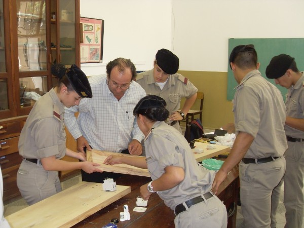 In June, Omar Difilippo, a professor at General Belgrano, works with cadets to install electrical boards, as part of a project funded by a Science Teaching Tools Award from the chapter. 