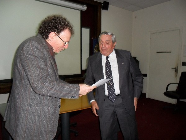 Rear Adm. Emilio Nigoul, ARA (Ret.), chapter president, presents a certificate of recognition to Rinaldi for his speech at the April conference.