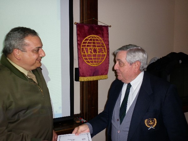 Lt. Col. Miguel Angel Blanco, EA (Ret.) (l), receives a certificate from Adm. Nigoul at the October symposium.